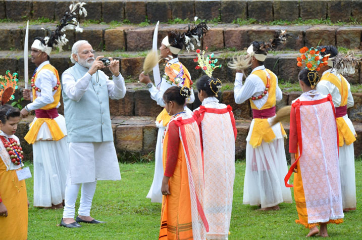Prime Minister Narendra Modi seen photographing a cultural troupe