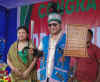 Dr Mukul Sangma with a Milam and Danil (sword and shield) during the felicitation programme held at Ampati