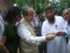 Governor being shown a document to prove Mir Jumla was buried in the site