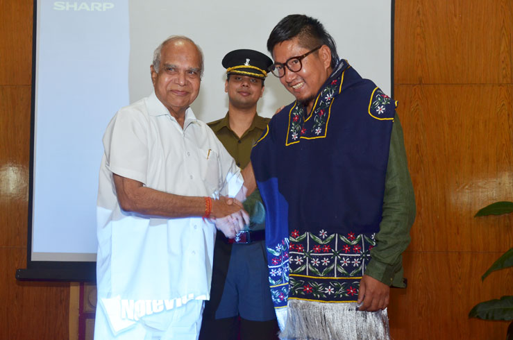 Governor of Meghalaya Shri Banwarilal Purohit felicitating the director of the Documentary film My name is Eeooow Oinam Doren